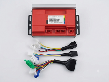 A red electronic control module with a silver heatsink top and black side brackets, shown on a white background with attached multicolored wiring harnesses and connectors.