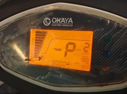 Digital display on a vehicle's dashboard with 'OKAYA' branding