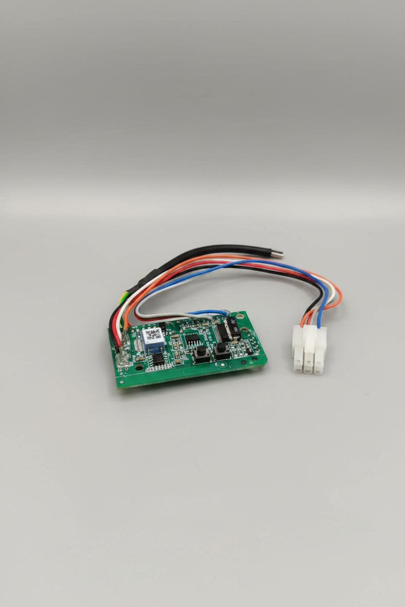 Small electronic circuit board with wires on a red surface