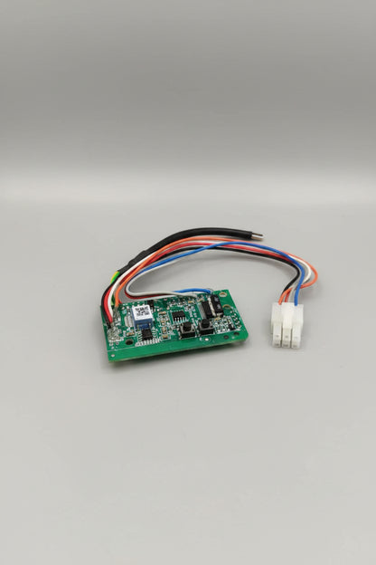Small electronic circuit board with wires on a red surface