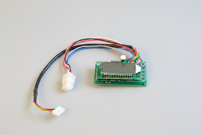 Electronic circuit board with wires on a red fabric background