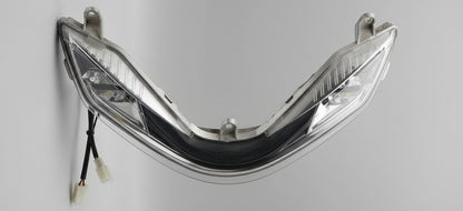 Car headlight assembly with plastic cover removed, showing internal components.
