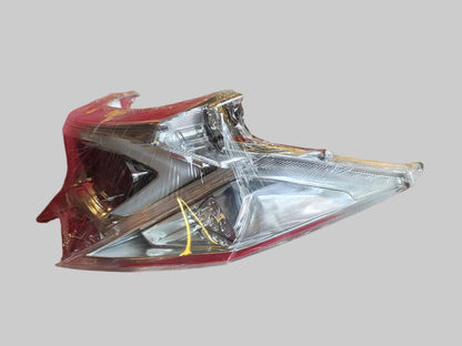 Motorcycle headlight in clear plastic packaging on a red surface
