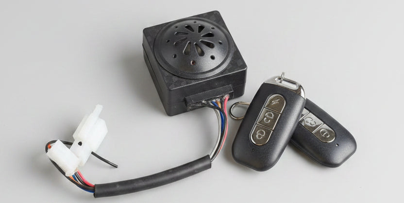 Vintage-style fire starter with sparkplug and remote control on a red surface