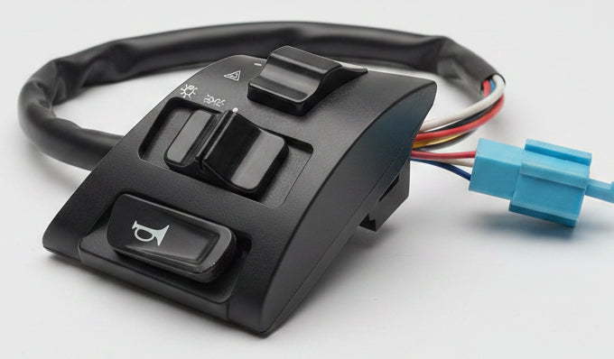 Car window switch panel with wiring on a red surface