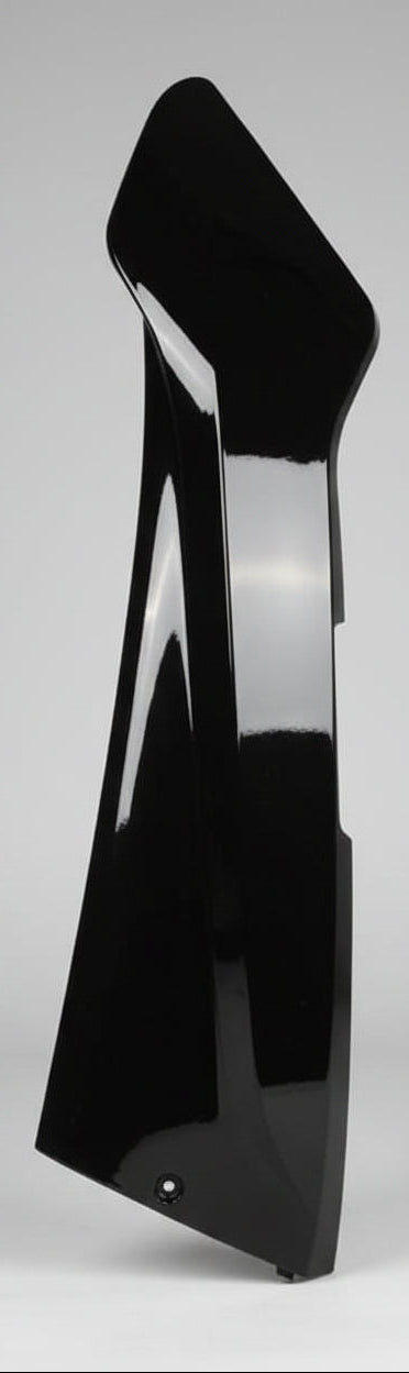 A glossy black plastic or fiberglass body panel, likely a fender or side skirt, shown on a neutral gray background.