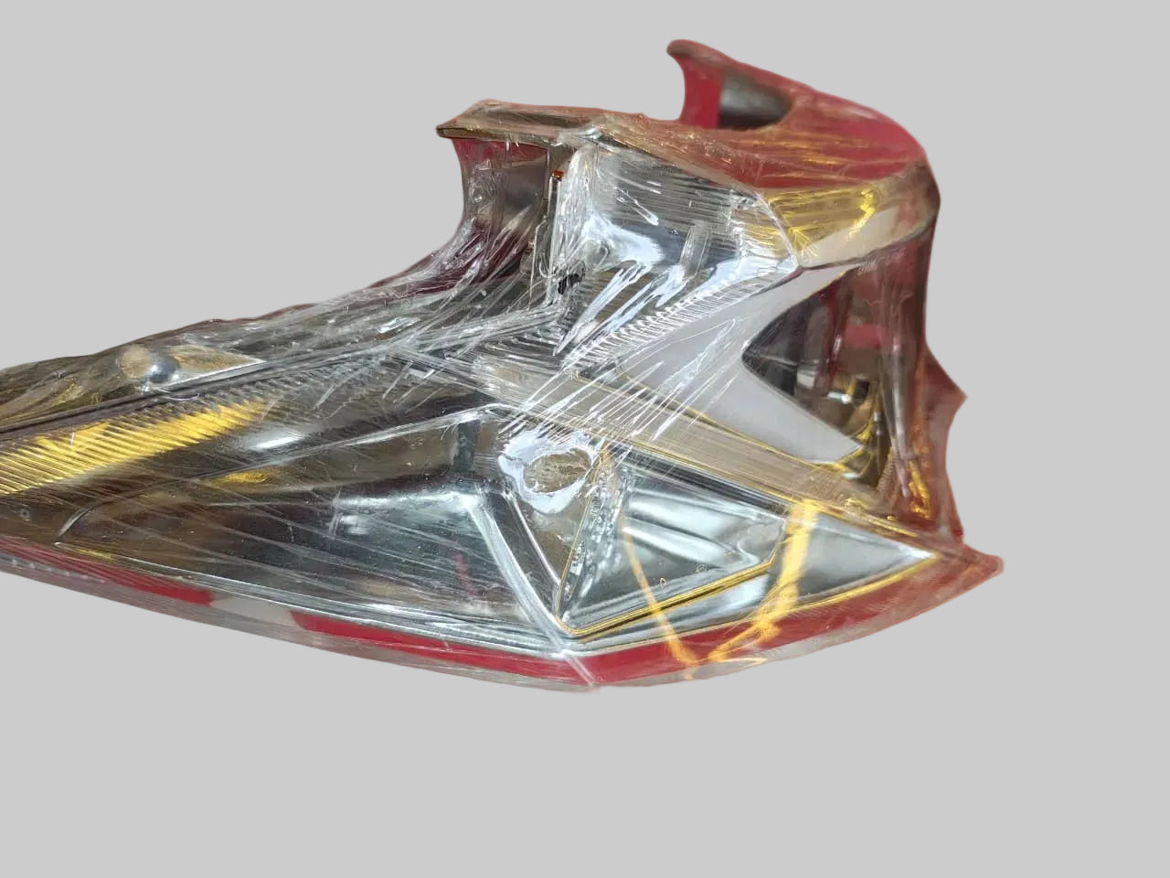 Motorcycle headlight on a red surface