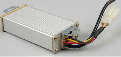 Rectangular metal component with wires on a dark textured surface