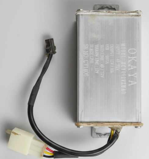 Battery with wires on a dark textured surface